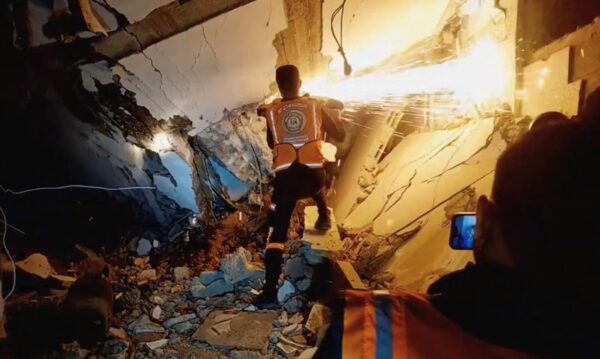 A screen grab taken from a video posted on social media by the Palestinian Civil Defence on December 5, 2023, shows what they say are members of the Palestinian Civil Defence rescue team working in a collapsed building in a location given as Gaza. Palestinian Civil Defence/Handout via REUTERS THIS IMAGE HAS BEEN SUPPLIED BY A THIRD PARTY. MANDATORY CREDIT. NO RESALES. NO ARCHIVES.