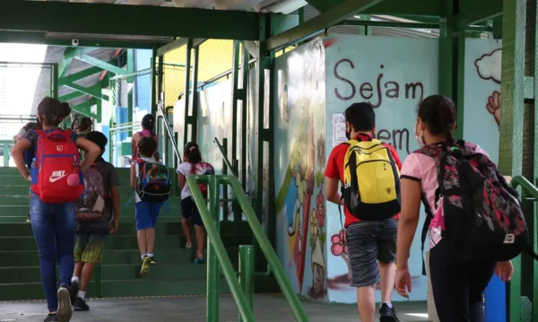 Crianças do ensino fundamental chegam para as aulas presenciais na Escola Estadual Terezine Arantes Ferraz Bibliotecaria, no Parque Casa de Pedra, zona norte da capital.