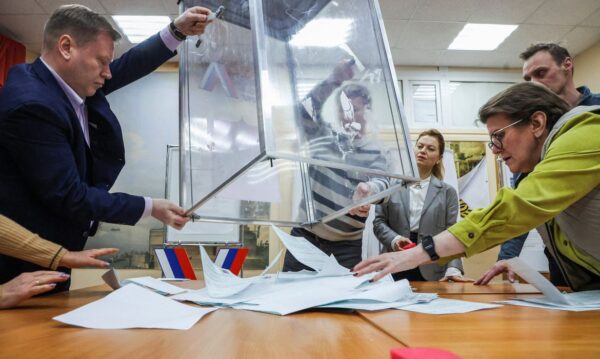Members of an electoral commission empty a ballot box, after polling stations closed on the final day of the presidential election in Saint Petersburg, Russia, March 17, 2024. REUTERS/Anton Vaganov