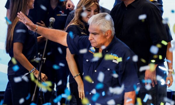 Presidential candidate Jose Raul Mulino waves on stage as his wife Marisel Cohen de Mulino looks towards him after he was declared the winner of the presidential election based on preliminary results by the electoral authority, in Panama City, Panama, May 5, 2024. REUTERS/Daniel Becerril TPX IMAGES OF THE DAY